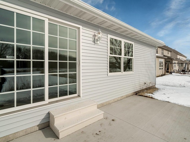 snow covered property with a patio