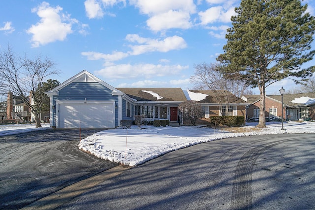 ranch-style house featuring aphalt driveway, a residential view, and an attached garage