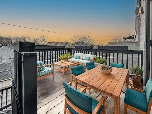 deck at dusk featuring an outdoor living space