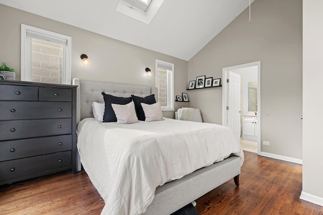 bedroom featuring ensuite bath, dark hardwood / wood-style flooring, a skylight, and high vaulted ceiling