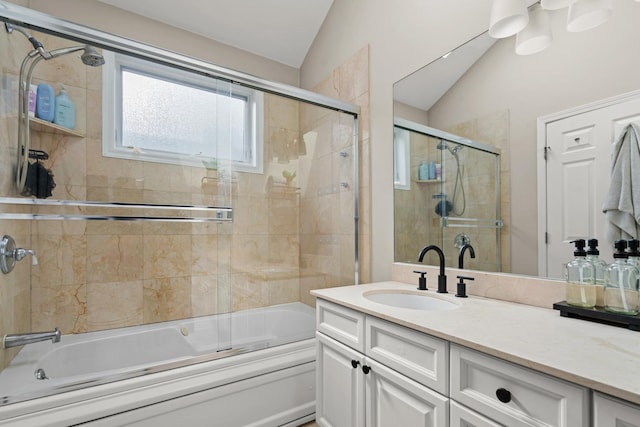 bathroom featuring lofted ceiling, shower / bath combination with glass door, and vanity