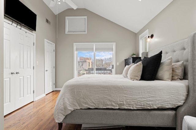 bedroom featuring hardwood / wood-style flooring, ceiling fan, high vaulted ceiling, and access to outside