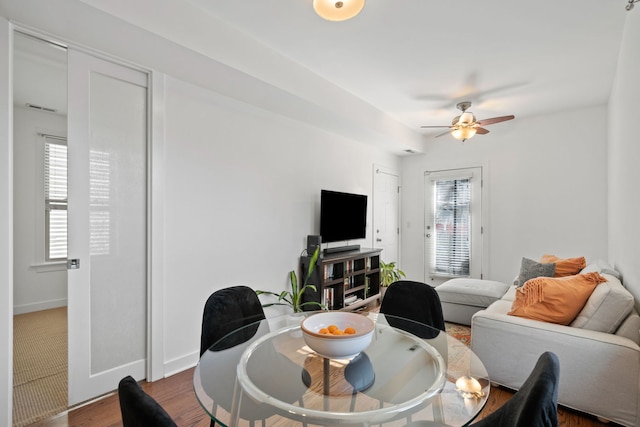 dining room featuring dark wood-type flooring and ceiling fan