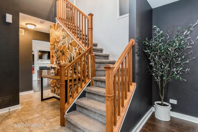 stairway with visible vents and baseboards