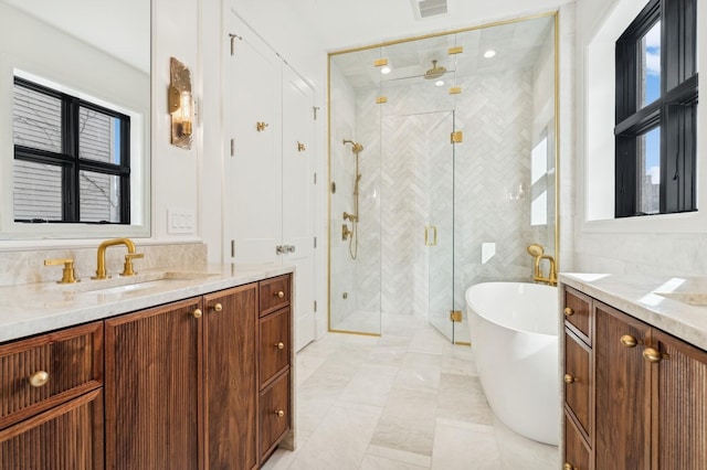 bathroom featuring vanity, plus walk in shower, and tile walls