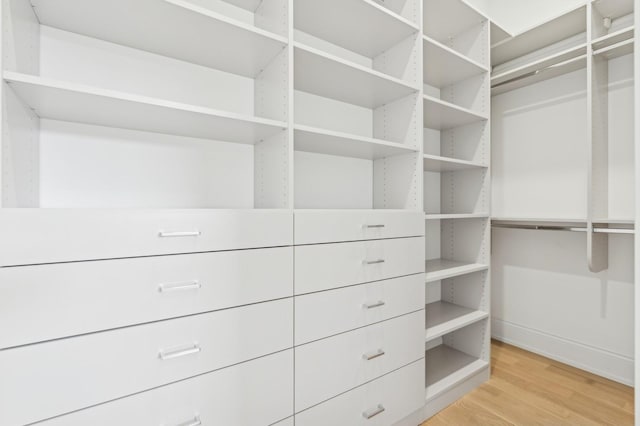 spacious closet featuring light hardwood / wood-style floors