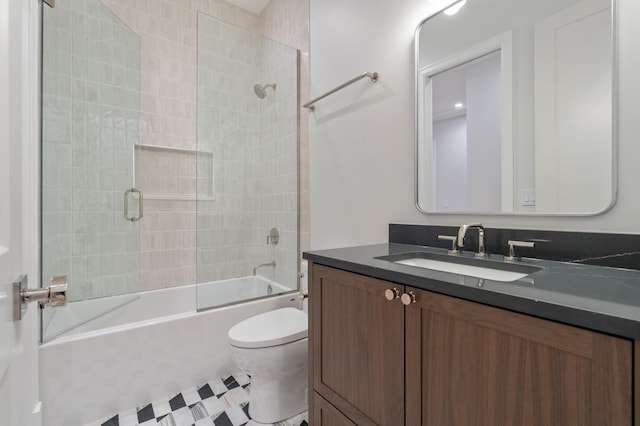 full bathroom featuring shower / bath combination with glass door, vanity, and toilet