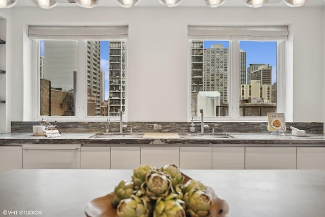 bathroom with a city view and vanity