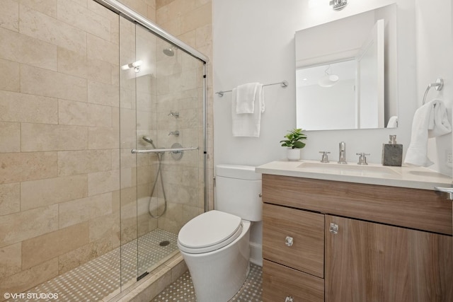 full bath featuring toilet, a shower stall, and vanity