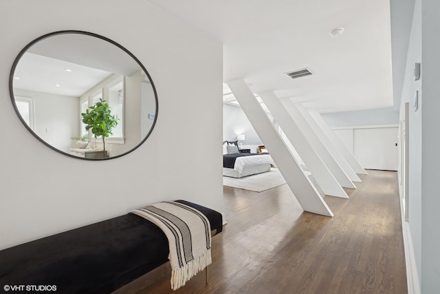 corridor featuring stairway, visible vents, and wood finished floors