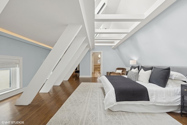 bedroom featuring lofted ceiling with beams and wood finished floors