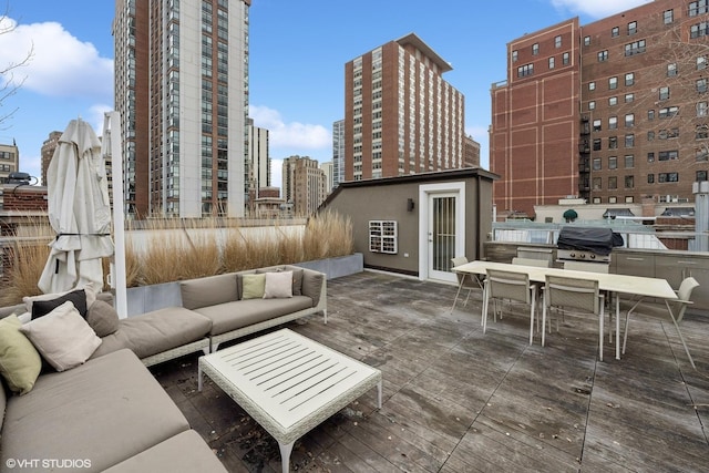 deck with a view of city, outdoor dining space, area for grilling, and an outdoor hangout area