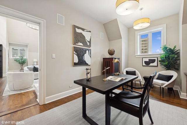 office space with visible vents, baseboards, and wood finished floors