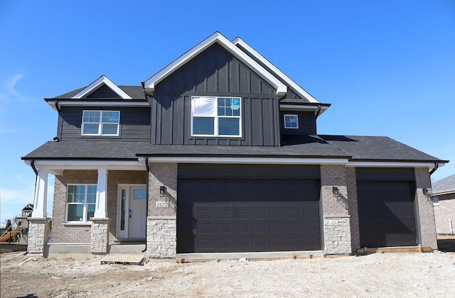 view of front of property with a garage, brick siding, board and batten siding, and a shingled roof