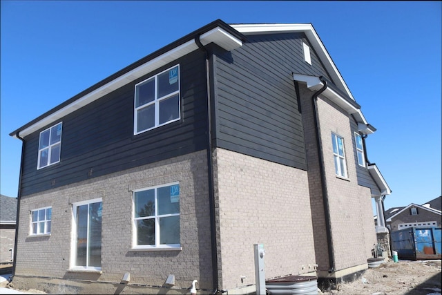 back of house featuring brick siding