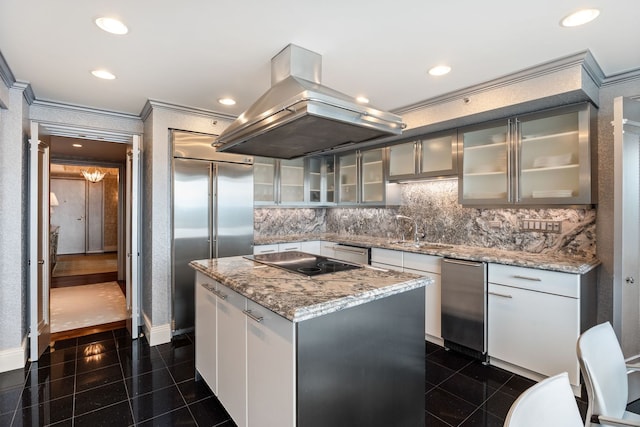 kitchen with black electric cooktop, island range hood, a center island, and dark tile patterned flooring