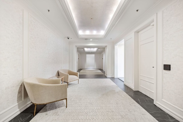 hall featuring ornamental molding and a tray ceiling