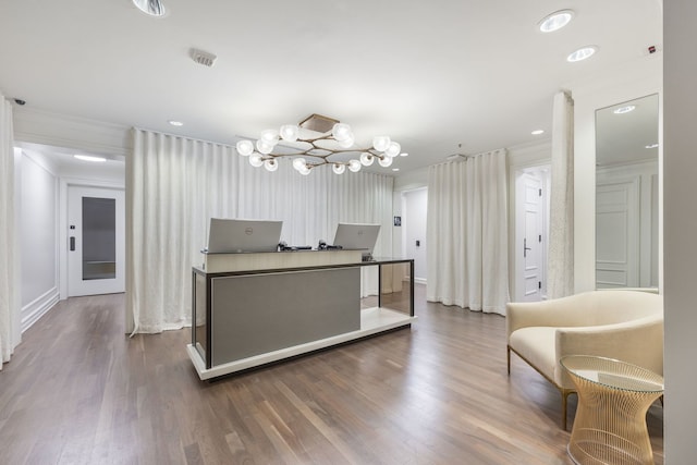 interior space featuring crown molding, an inviting chandelier, and hardwood / wood-style floors