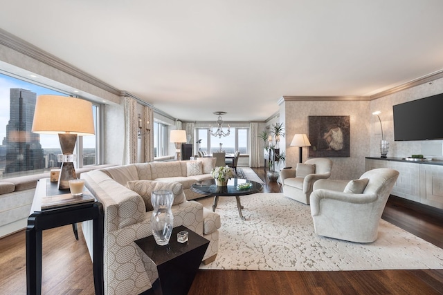 living room featuring hardwood / wood-style floors, a notable chandelier, and ornamental molding