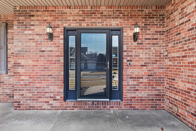 property entrance featuring brick siding