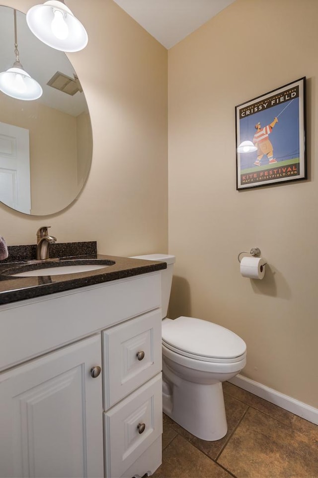 bathroom with toilet, baseboards, visible vents, and vanity