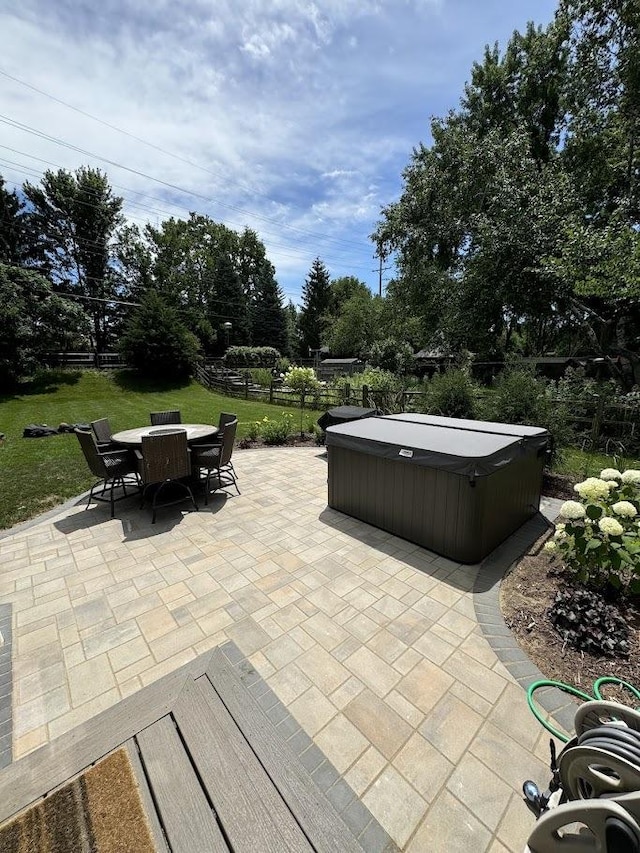 view of patio / terrace with outdoor dining area, fence, and a hot tub