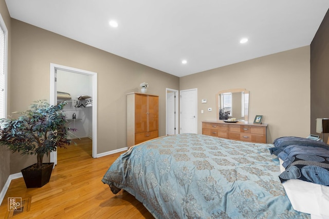 bedroom featuring light wood finished floors, baseboards, and recessed lighting