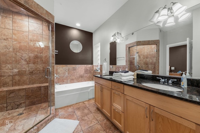 bathroom featuring a garden tub, double vanity, a stall shower, a sink, and tile patterned floors