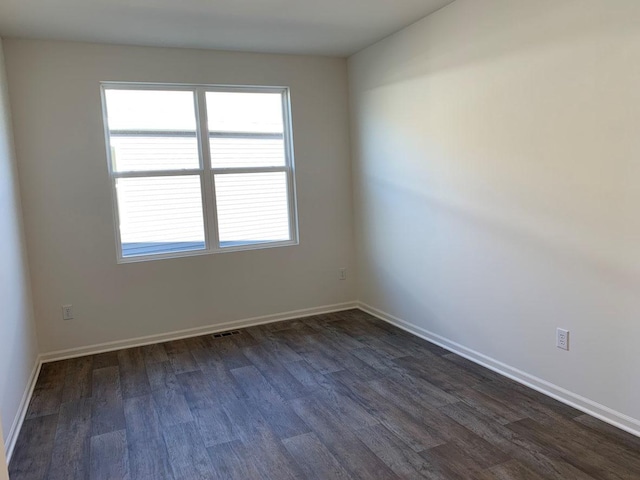 empty room featuring dark hardwood / wood-style floors