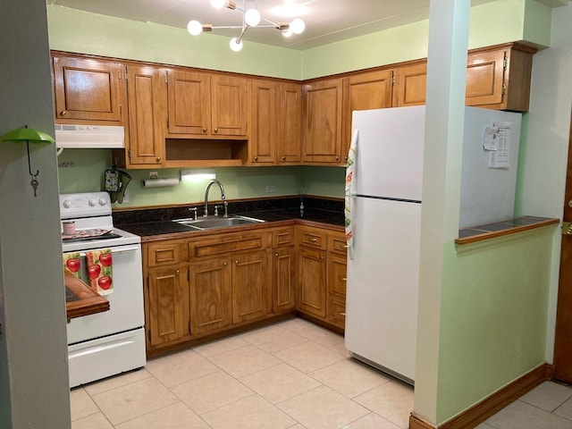 kitchen featuring sink, white appliances, light tile patterned floors, and a chandelier