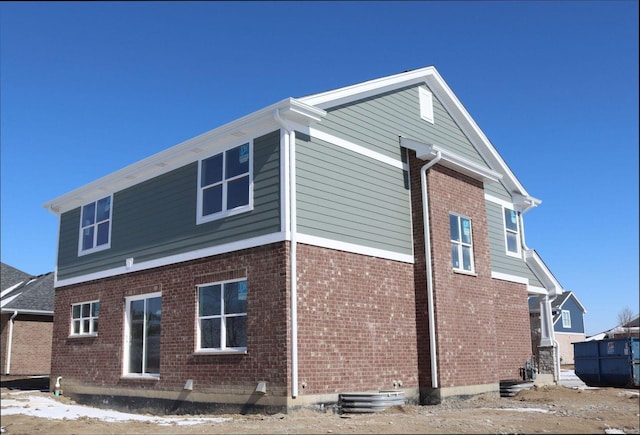 view of side of home featuring brick siding