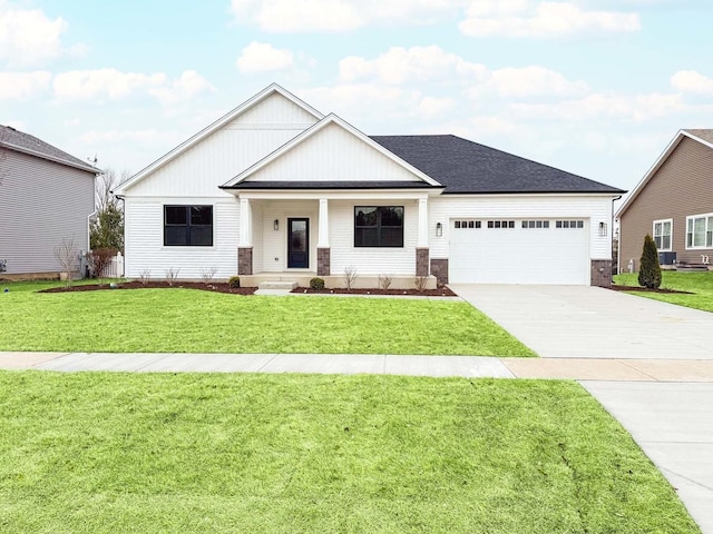 view of front facade with a garage, a front yard, and covered porch