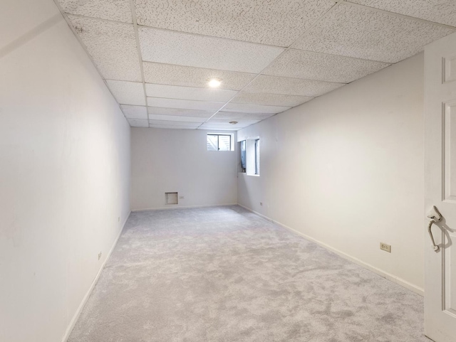 basement with carpet and a drop ceiling