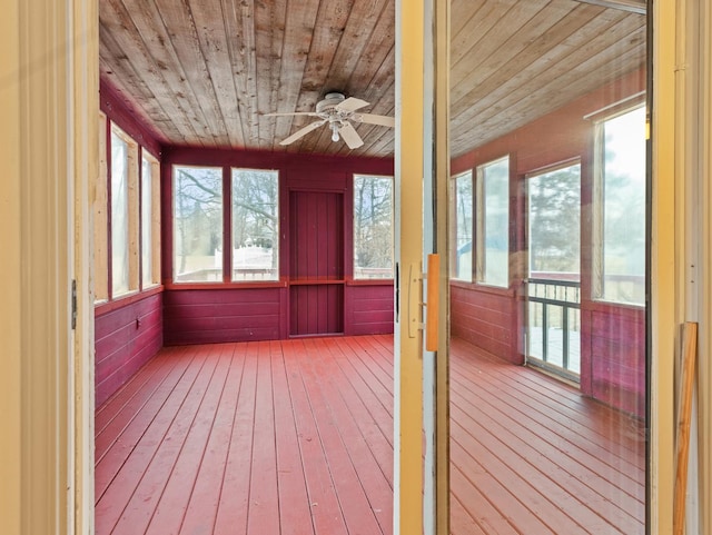 unfurnished sunroom with ceiling fan and wood ceiling