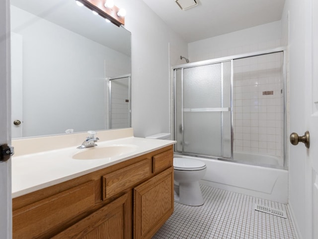 full bathroom with tile patterned flooring, vanity, toilet, and combined bath / shower with glass door