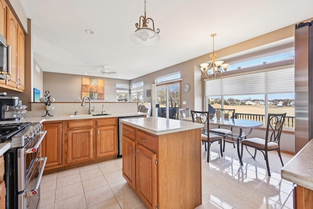 kitchen featuring light tile patterned floors, sink, pendant lighting, a kitchen island, and stainless steel appliances