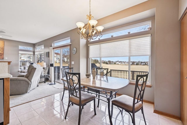 dining room featuring a notable chandelier and light tile patterned floors