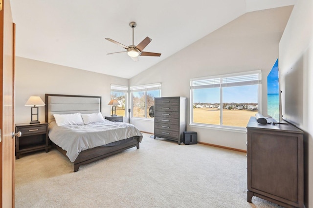 bedroom with ceiling fan, high vaulted ceiling, and light carpet