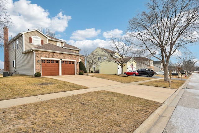 exterior space featuring a garage, central AC, and a front lawn