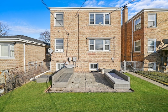 rear view of house featuring a yard and a patio