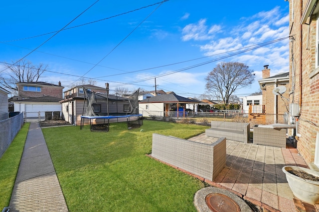 view of yard with a trampoline, a patio area, and outdoor lounge area