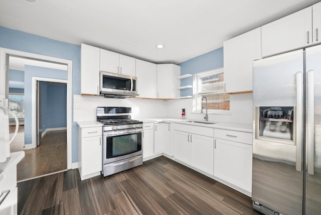 kitchen with sink, white cabinets, and appliances with stainless steel finishes