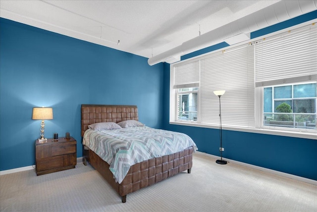 carpeted bedroom featuring multiple windows and a textured ceiling