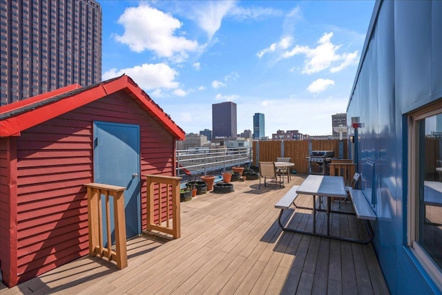 wooden deck featuring a grill