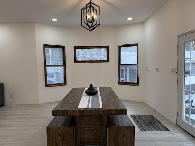 dining space featuring an inviting chandelier and light hardwood / wood-style floors