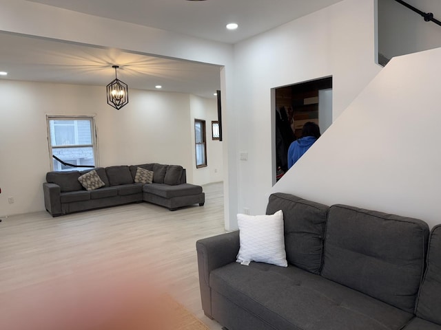 living room featuring light hardwood / wood-style flooring and a chandelier