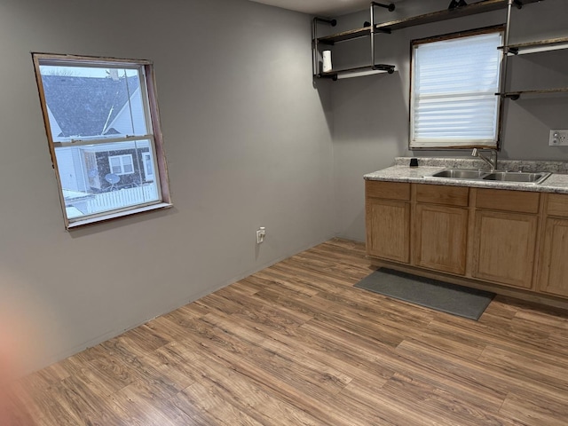 kitchen with cooling unit, sink, and light wood-type flooring