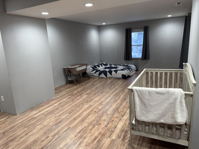 bedroom with hardwood / wood-style flooring