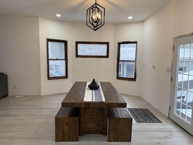 dining space featuring a chandelier and light hardwood / wood-style flooring