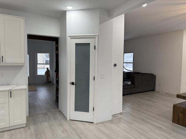 corridor with light hardwood / wood-style flooring